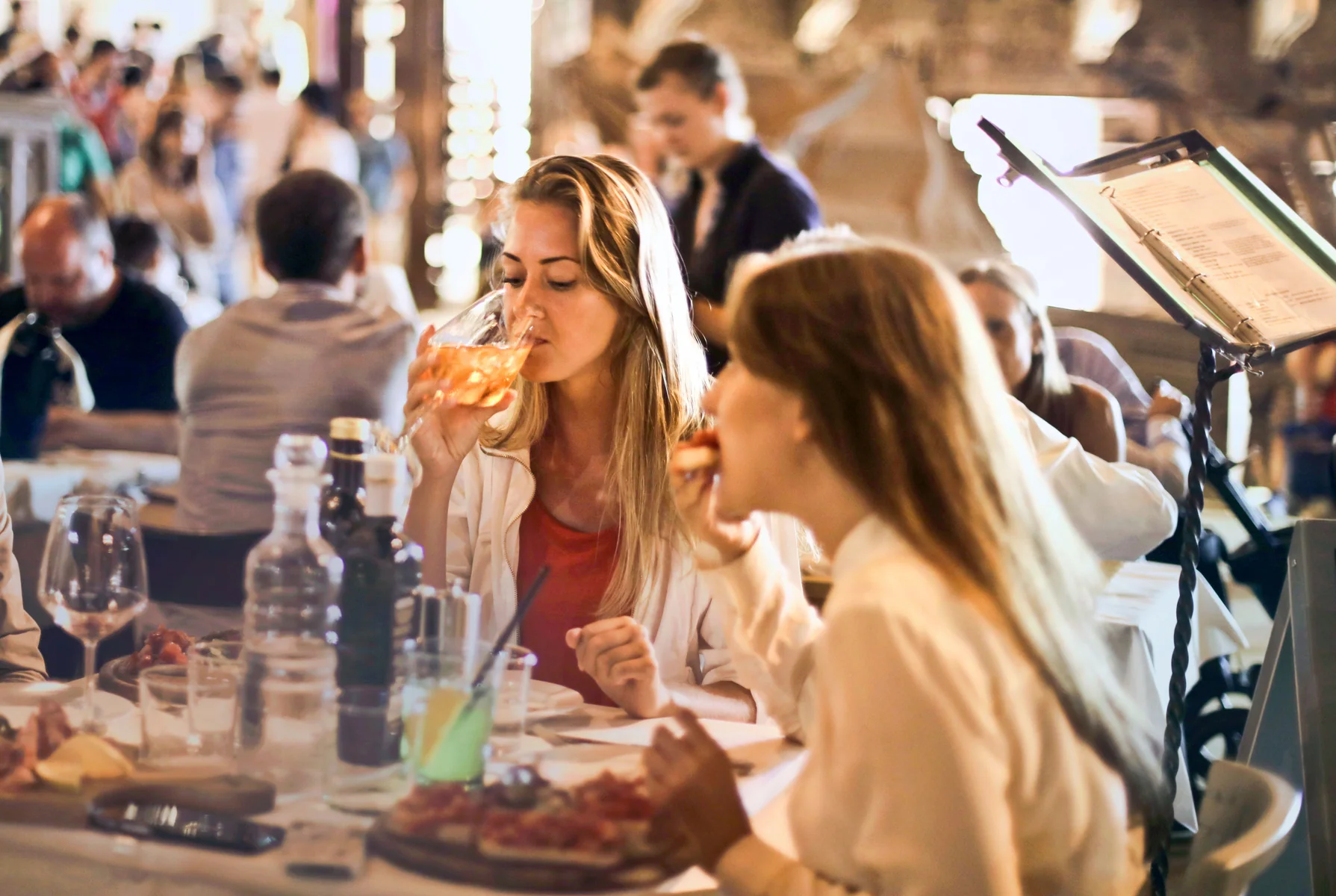 Guests sharing Italian food and wine in a restaurant