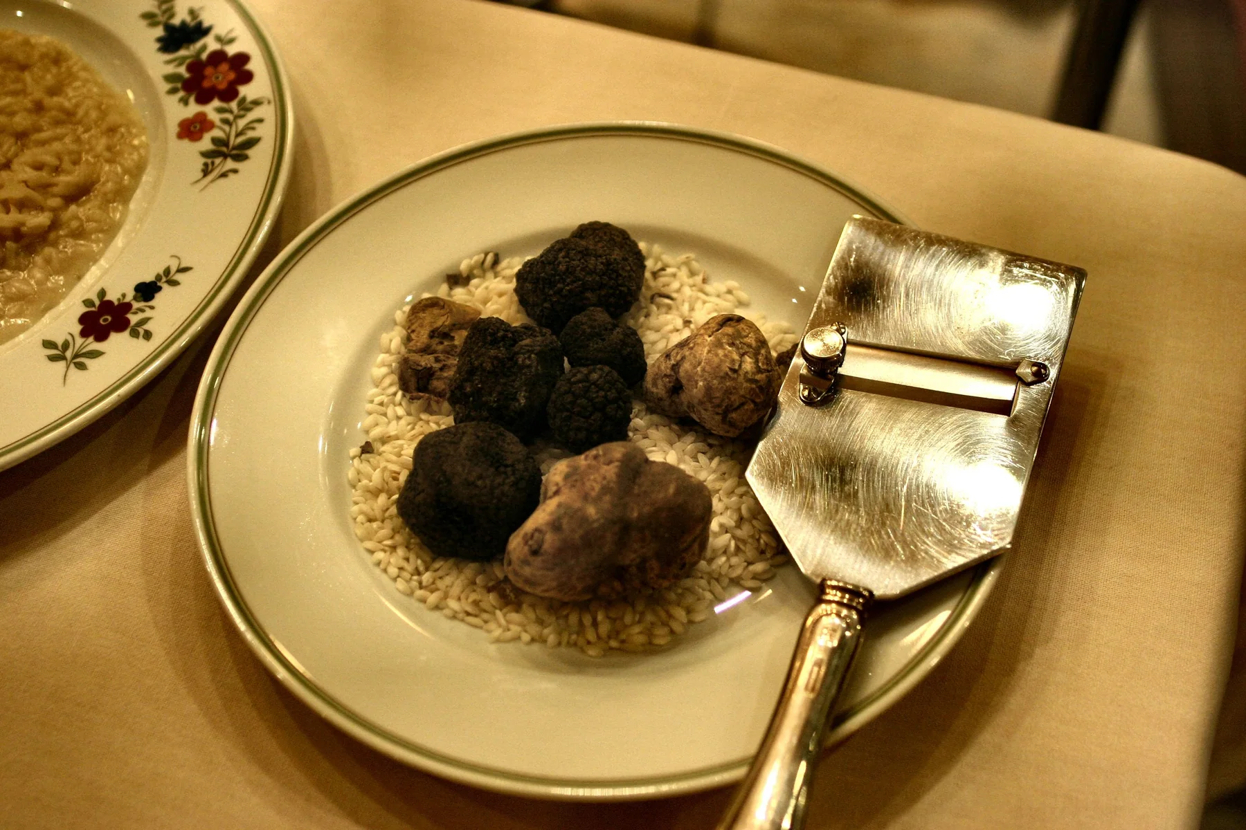 Fresh black truffles with a truffle slicer